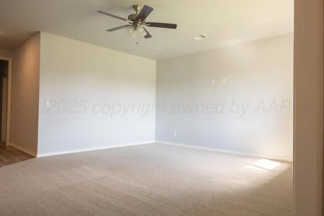 a view of a big room with carpet