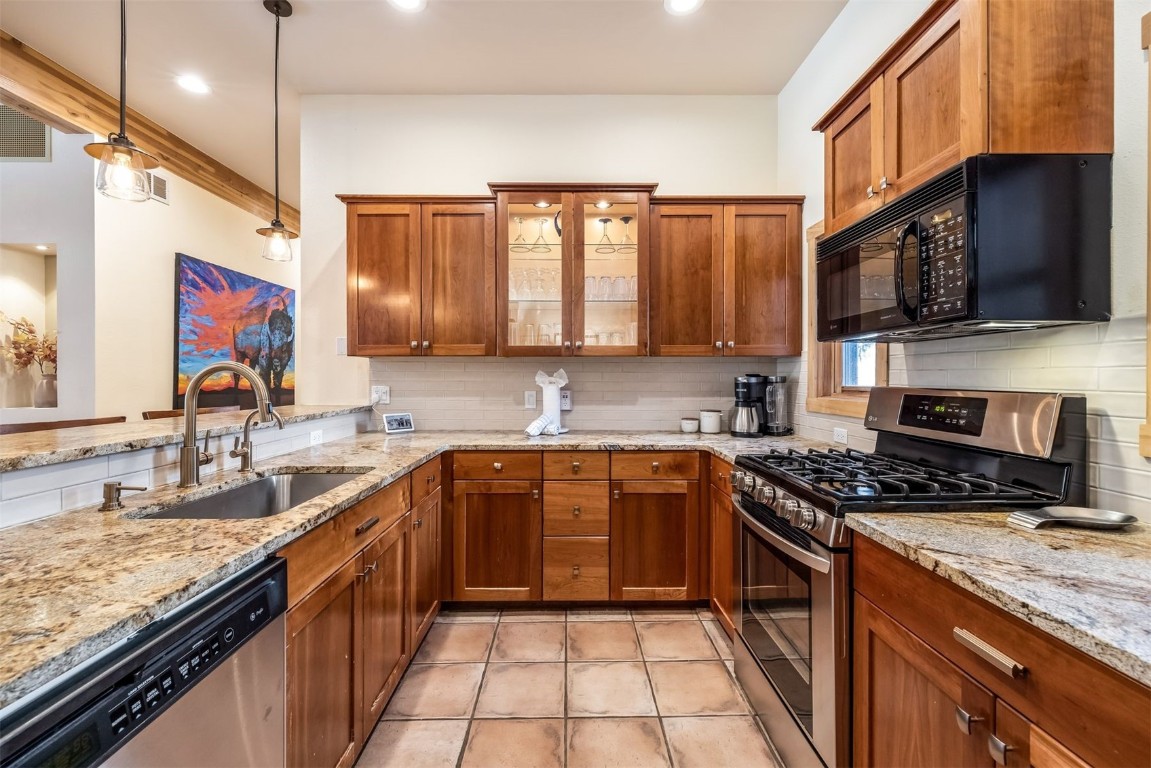 56 River Run Road, Unit 201 Keystone, CO 80435 - Photo 15 of 44 a large kitchen with stainless steel appliances granite countertop a stove sink and cabinets