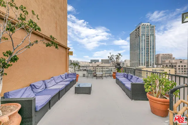 a balcony with furniture and city view