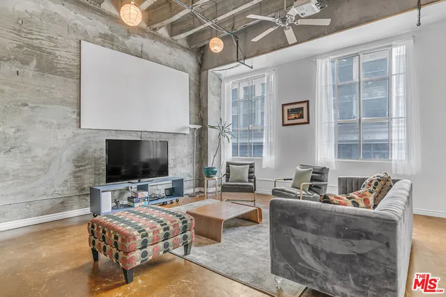 a living room with furniture and a flat screen tv