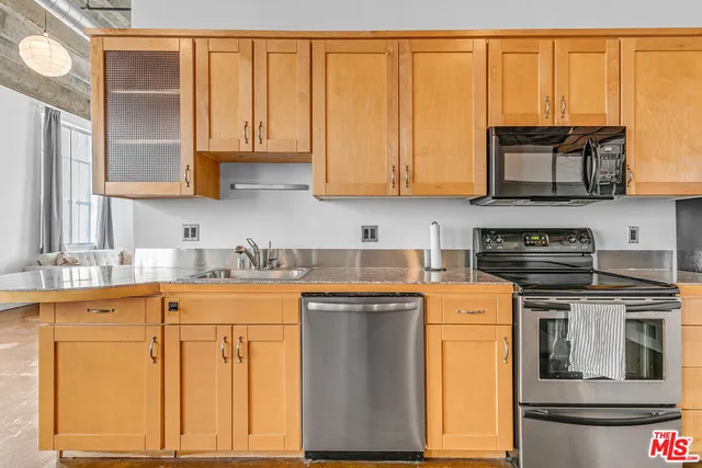 a kitchen with stainless steel appliances granite countertop a stove a sink and dishwasher