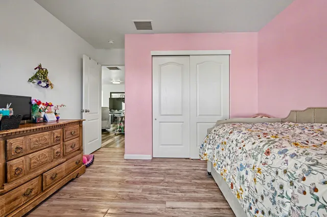 a bedroom with a bed and a dresser in it