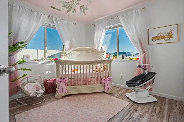 a spacious bedroom with a bed and a chandelier