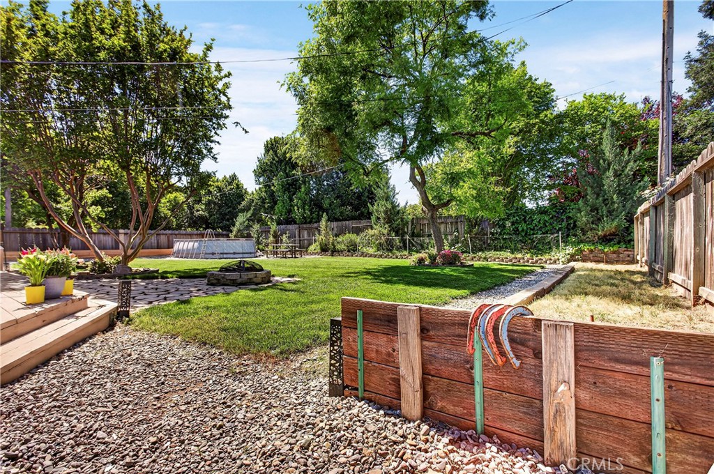 6 Mayfair Drive Chico, CA 95973 - Photo 44 of 52 angled shot of the backyard, there are fruit trees and to the right there is a horse pitts
