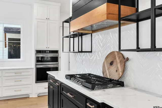 a kitchen with stainless steel appliances granite countertop a stove and a microwave
