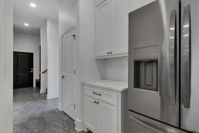 a view of hallway with stairs and furniture