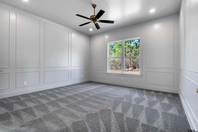 an empty room with windows and a fireplace