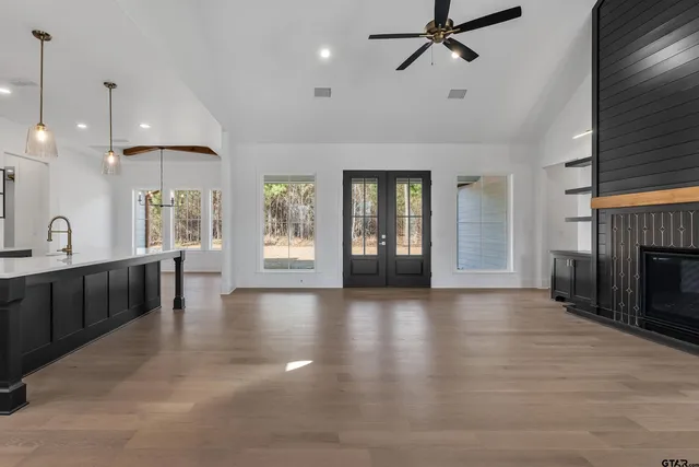a view of an empty room with a fireplace and a window