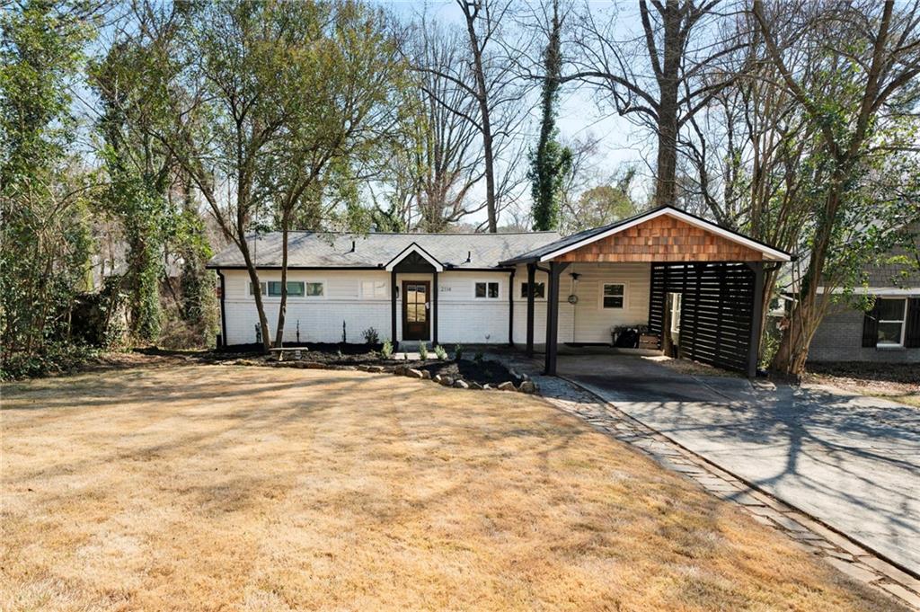 2114 Drew Valley Road Northeast Brookhaven, GA 30319 - Photo 1 of 1 a front view of a house with a yard covered in snow