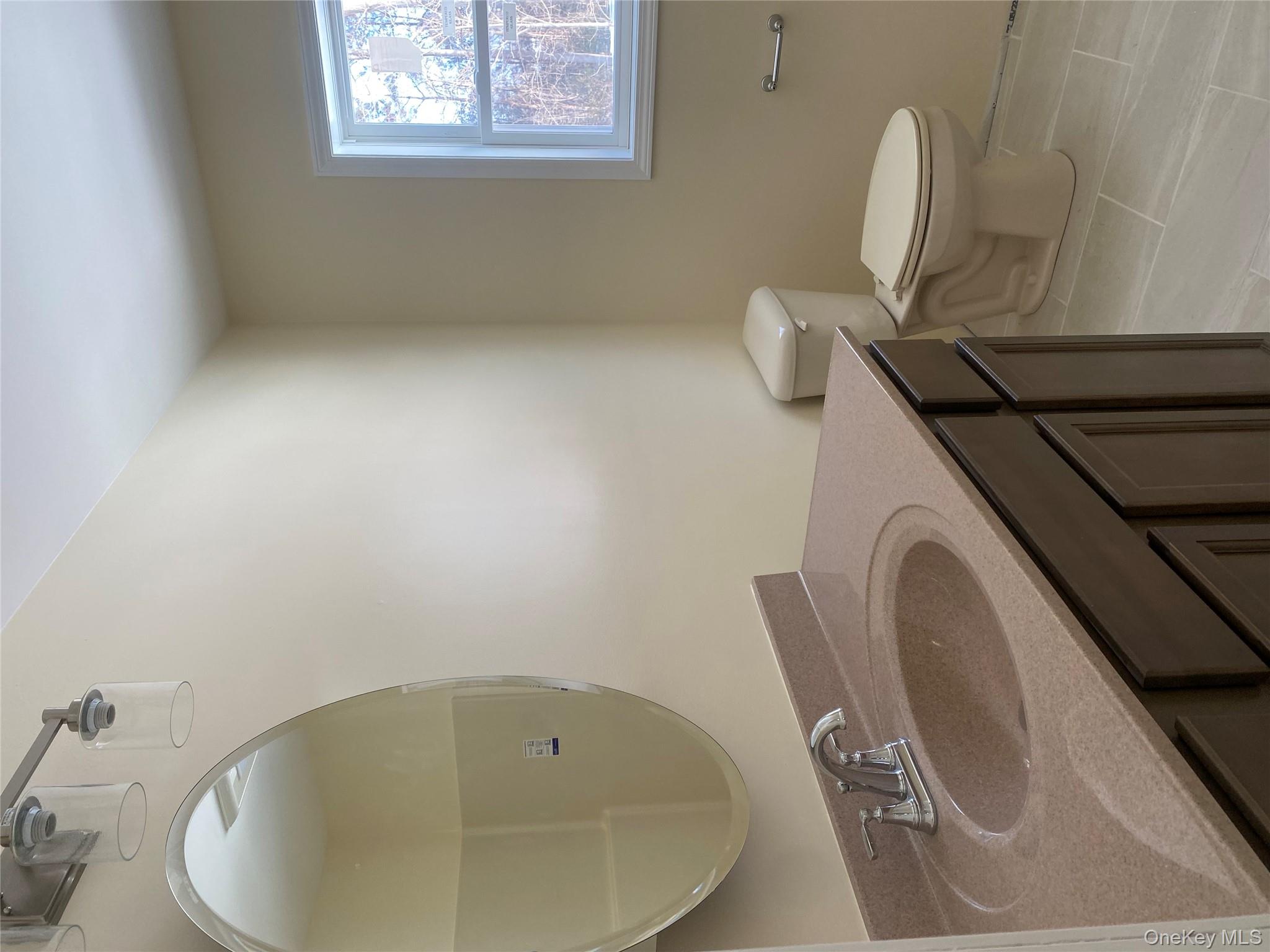 32 Spruce Road Brewster, NY 10509 - Photo 10 of 14 a bathroom with a granite countertop sink and a mirror