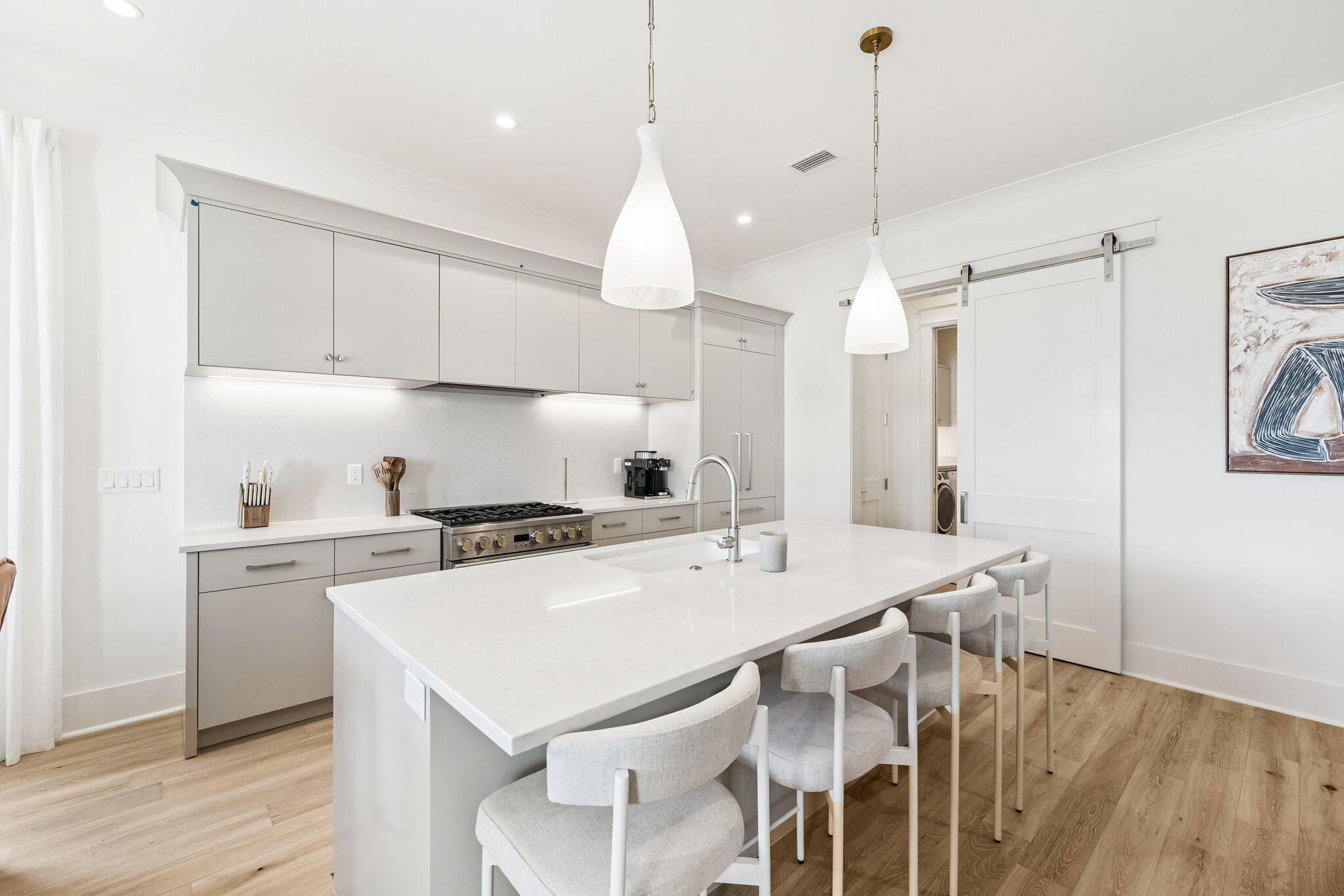 41 West Pollard Cove Inlet Beach Inlet Beach, FL 32461 - Photo 23 of 54 a kitchen with a dining table chairs sink and cabinets