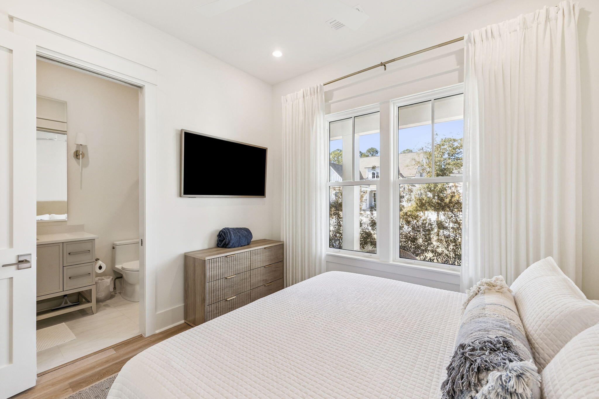 41 West Pollard Cove Inlet Beach Inlet Beach, FL 32461 - Photo 34 of 54 a bedroom with a bed and a flat tv screen on the dresser