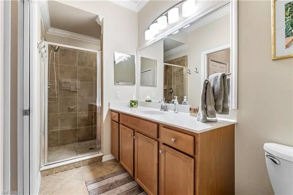 a bathroom with a shower sink and mirror