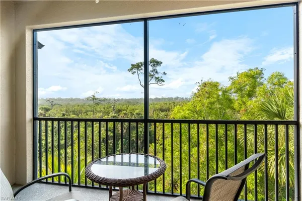 a view of a balcony with furniture