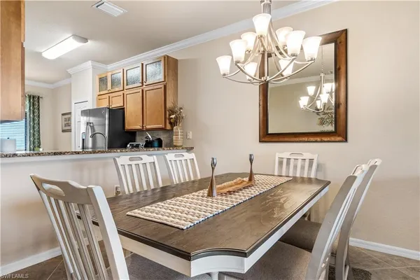a view of a dining room with furniture and chandelier