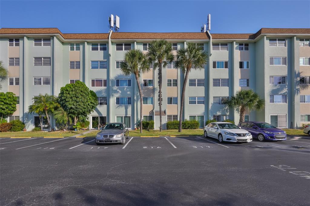 801 83rd Avenue North, Unit 118 St. Petersburg, FL 33702 - Photo 1 of 37 a car parked in front of a building with a view of street