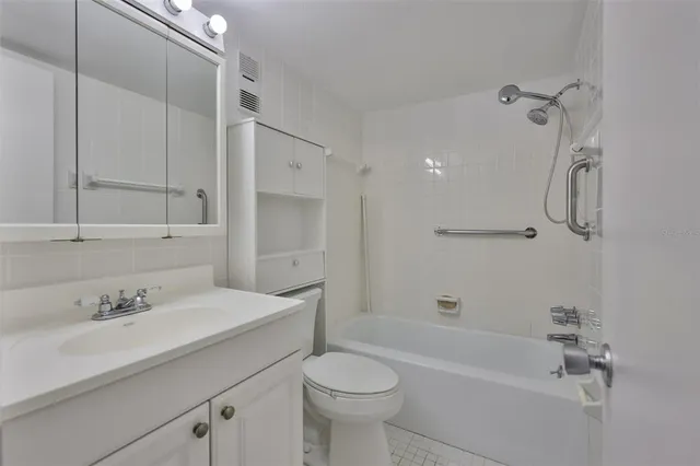 a bathroom with a sink toilet tub and shower