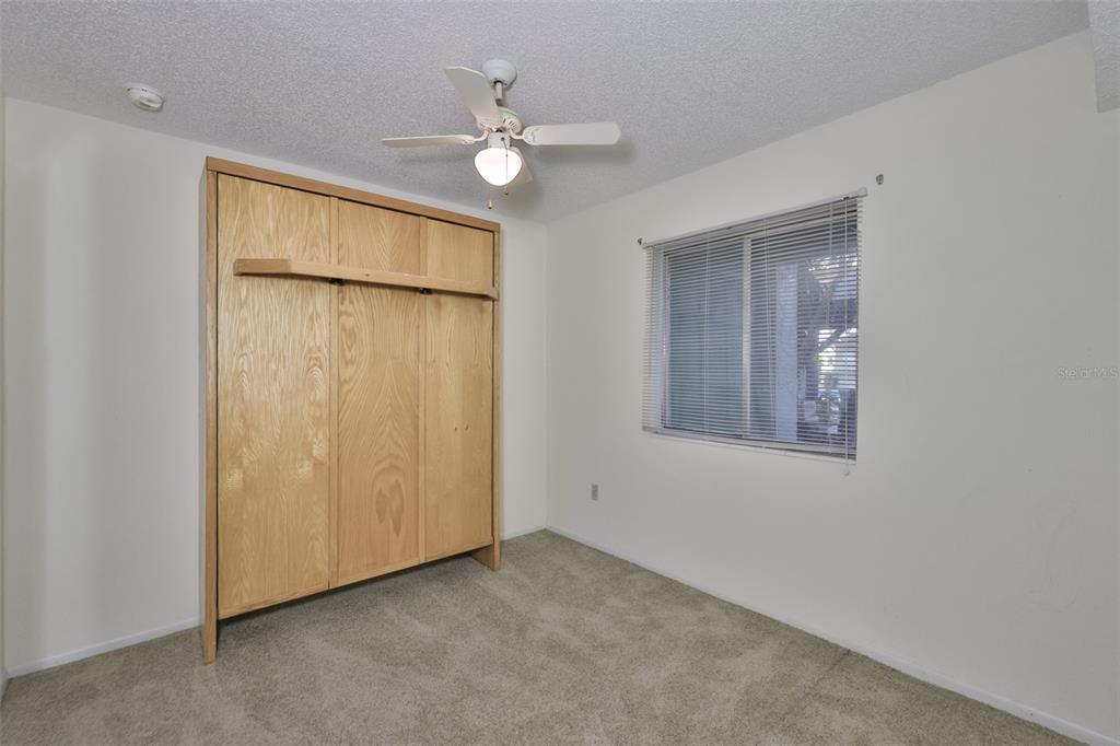 801 83rd Avenue North, Unit 118 St. Petersburg, FL 33702 - Photo 20 of 37 an empty room with chandelier fan