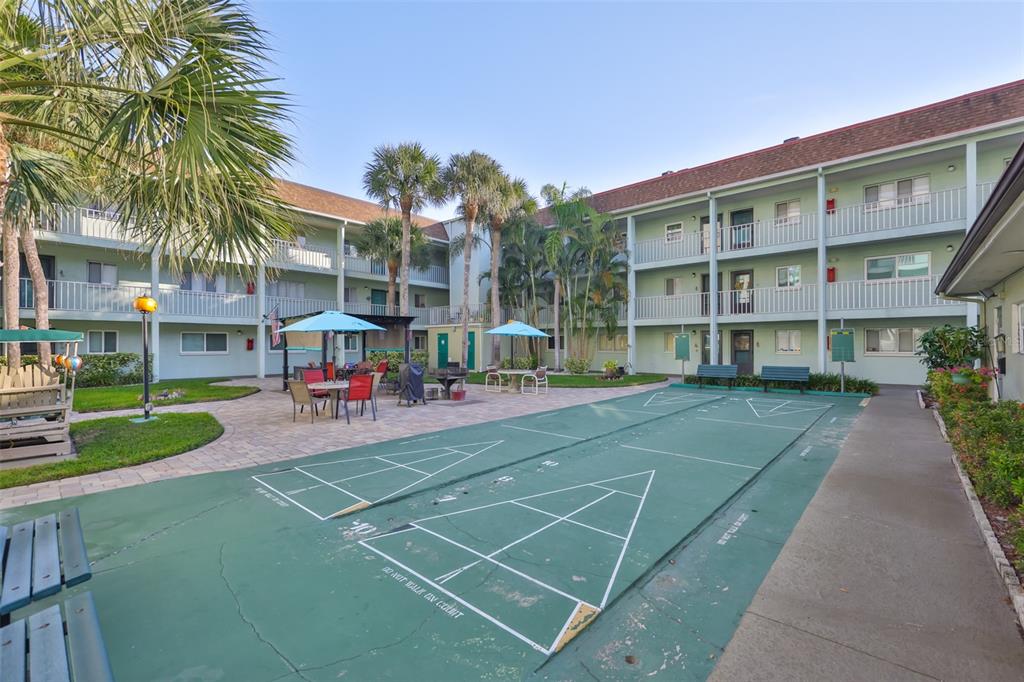 801 83rd Avenue North, Unit 118 St. Petersburg, FL 33702 - Photo 25 of 37 a view of a tennis ground with large trees