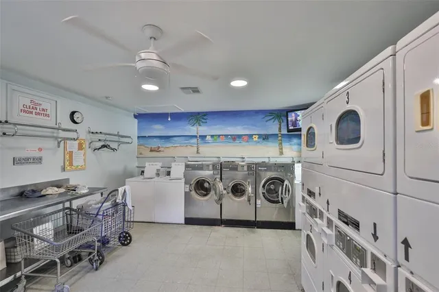 a utility room with stainless steel appliances granite countertop a stove and a refrigerator