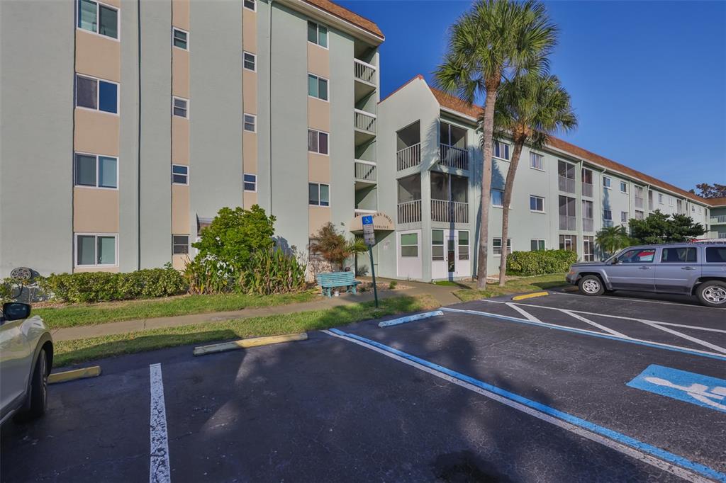 801 83rd Avenue North, Unit 118 St. Petersburg, FL 33702 - Photo 29 of 37 a front view of a building with garden