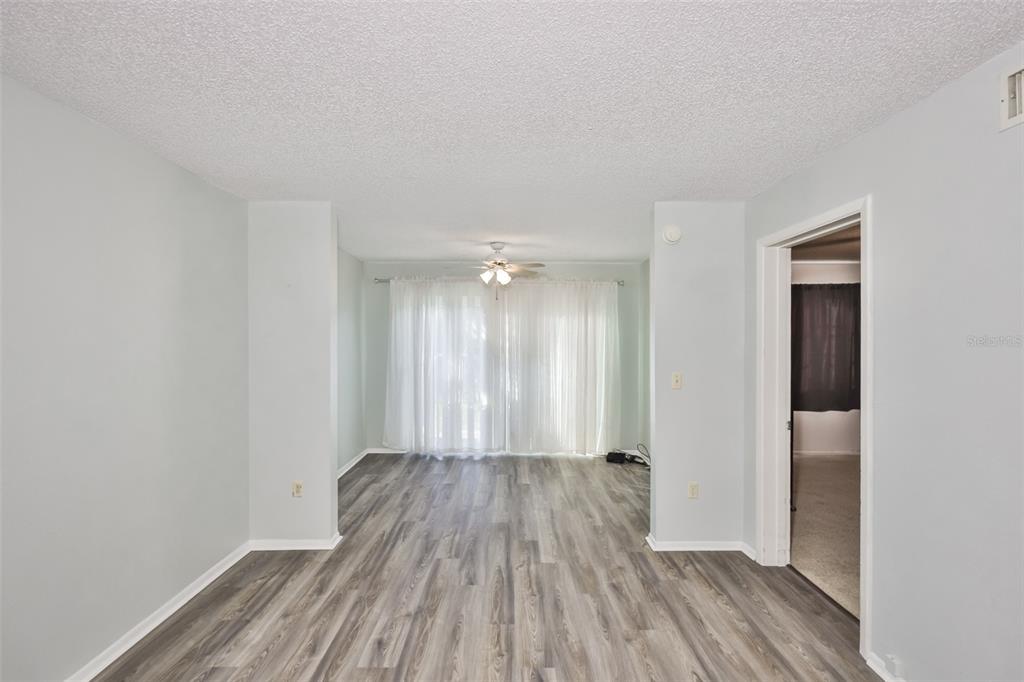 801 83rd Avenue North, Unit 118 St. Petersburg, FL 33702 - Photo 3 of 37 wooden floor in an empty room with a window