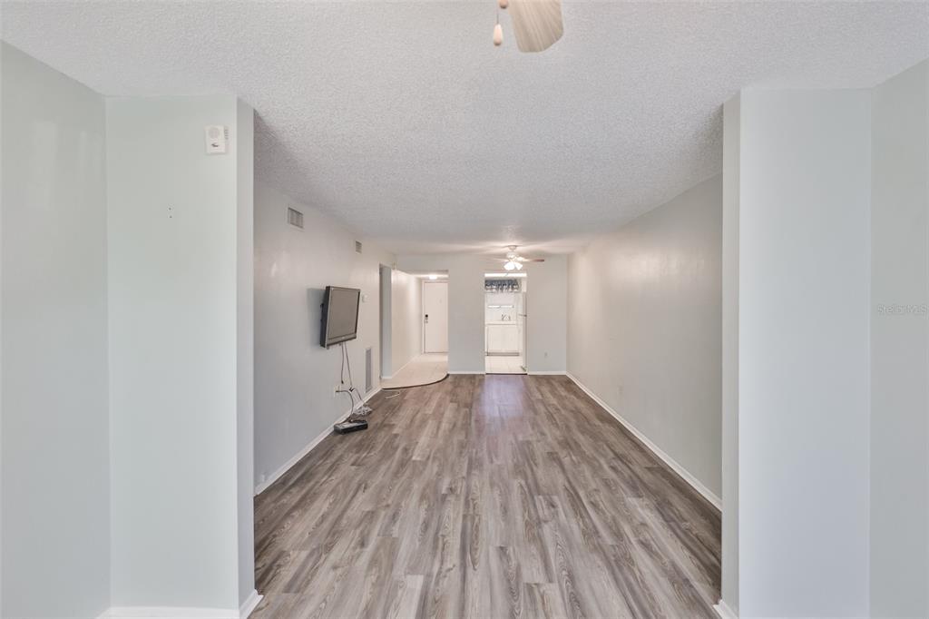 801 83rd Avenue North, Unit 118 St. Petersburg, FL 33702 - Photo 5 of 37 a view of a hallway with wooden floor