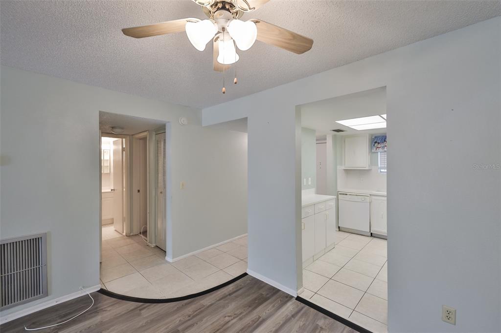 801 83rd Avenue North, Unit 118 St. Petersburg, FL 33702 - Photo 8 of 37 a view of an empty room with wooden floor and a window