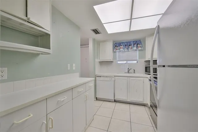 a kitchen with a sink cabinets and window