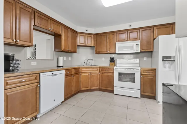 a kitchen with cabinets stainless steel appliances and a counter space