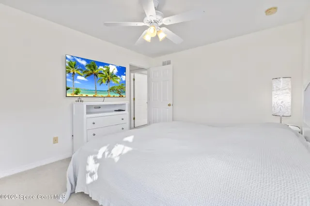 a bed room with furniture and painting on the wall