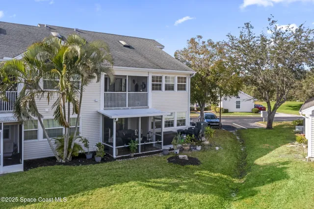 a view of a house with a yard porch and sitting area