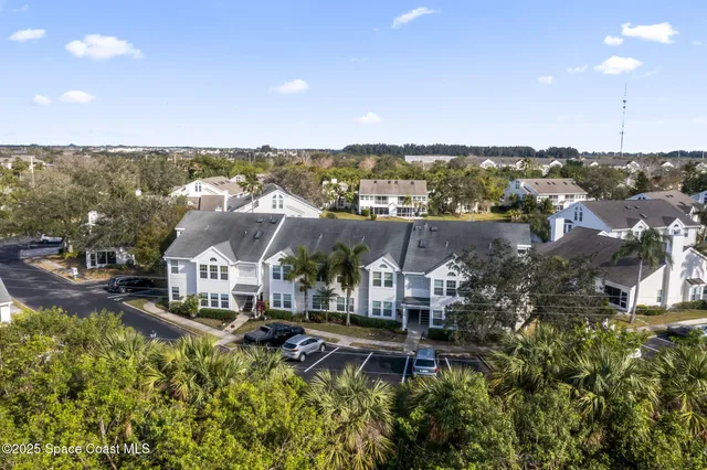 an aerial view of a house with a yard and lake view
