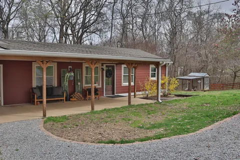 a view of a house with a backyard porch and sitting area