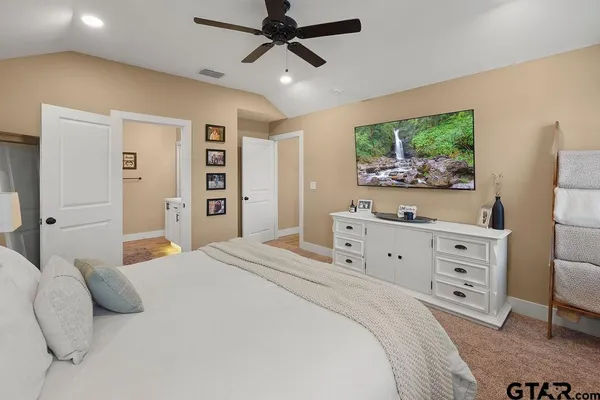 a bedroom with a bed and a flat screen tv