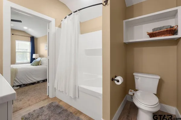 a bathroom with a toilet and a shower