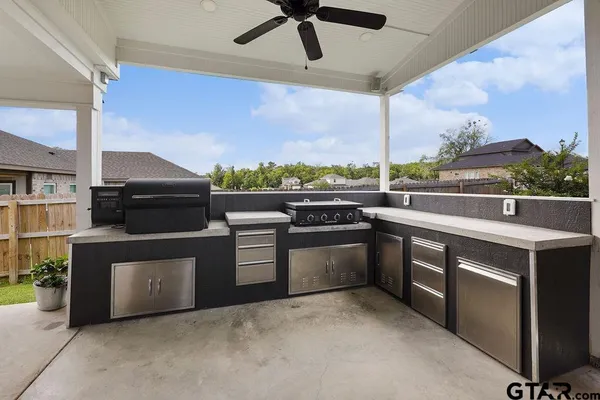 a kitchen with stainless steel appliances granite countertop a stove a sink and a microwave