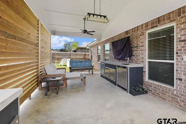 a view of a patio with a table and chairs