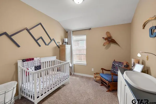 a bedroom with furniture and a window
