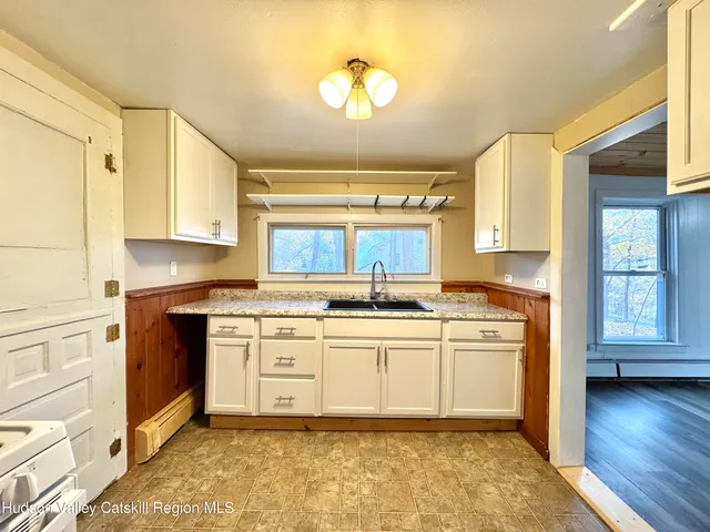 a kitchen with a stove a sink and a refrigerator