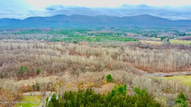 a view of a lush green hillside and a building