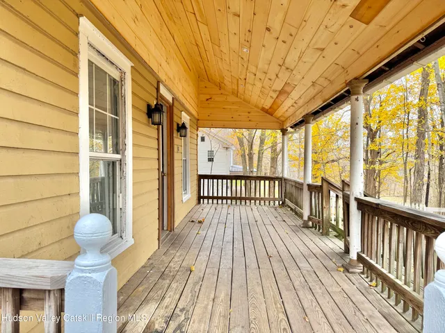 a view of a porch with wooden floor and outdoor space