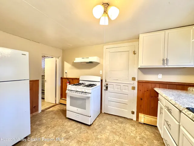 a kitchen with cabinets appliances and a counter space