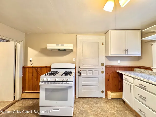 a kitchen with a stove and a refrigerator