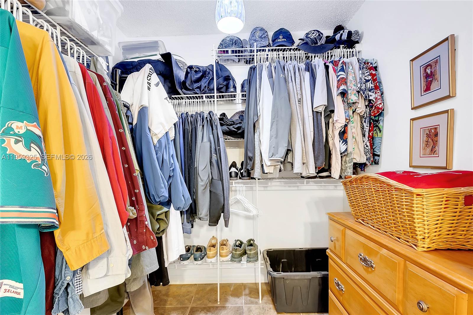 4534 Southwest 147th Court Miami, FL 33185 - Photo 15 of 22 a view of walk in closet with clothes