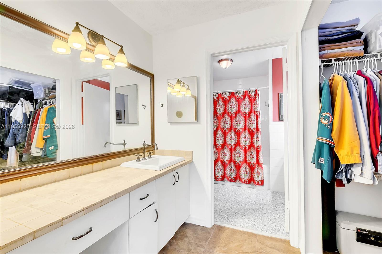 4534 Southwest 147th Court Miami, FL 33185 - Photo 8 of 22 a view of walk in closet with clothes and shoes