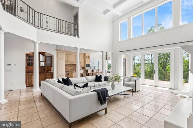 a view of a dining room with furniture a chandelier and wooden floor