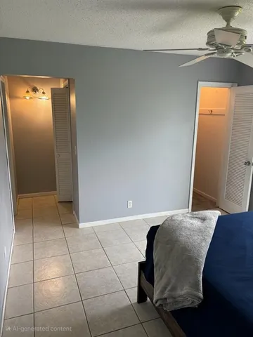 a bedroom with a bed and a potted plant