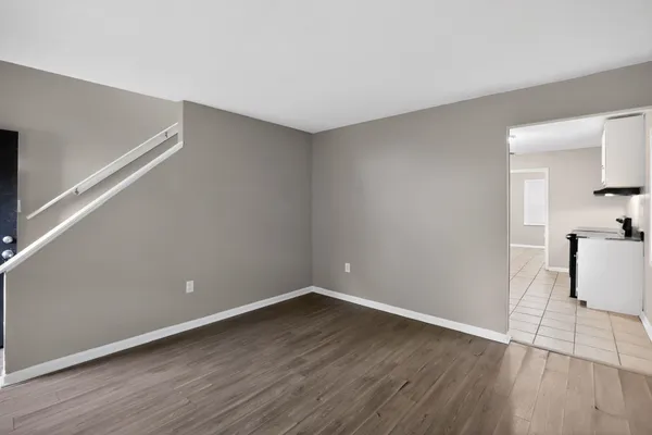 a view of a room with wooden floor and electronic appliances