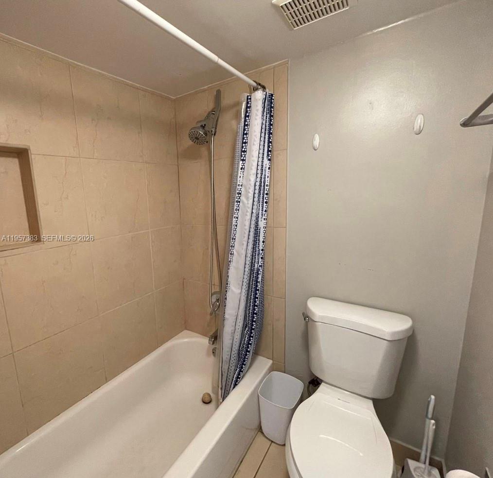16909 North Bay Road, Unit 807 Sunny Isles Beach, FL 33160 - Photo 9 of 15 a white toilet sitting next to a bath tub